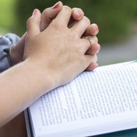 Student with hands on book